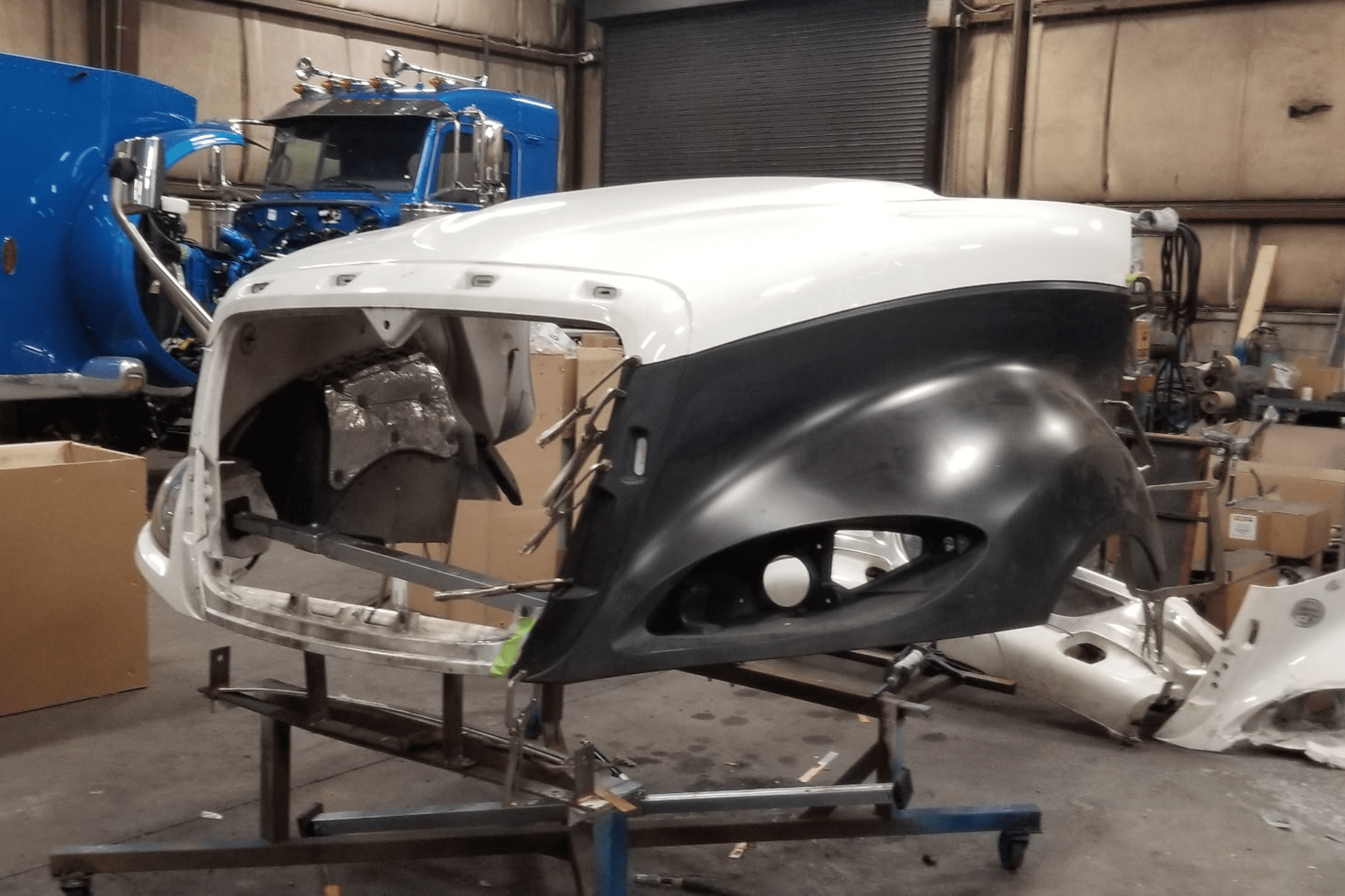 Truck hood assembly in a workshop.