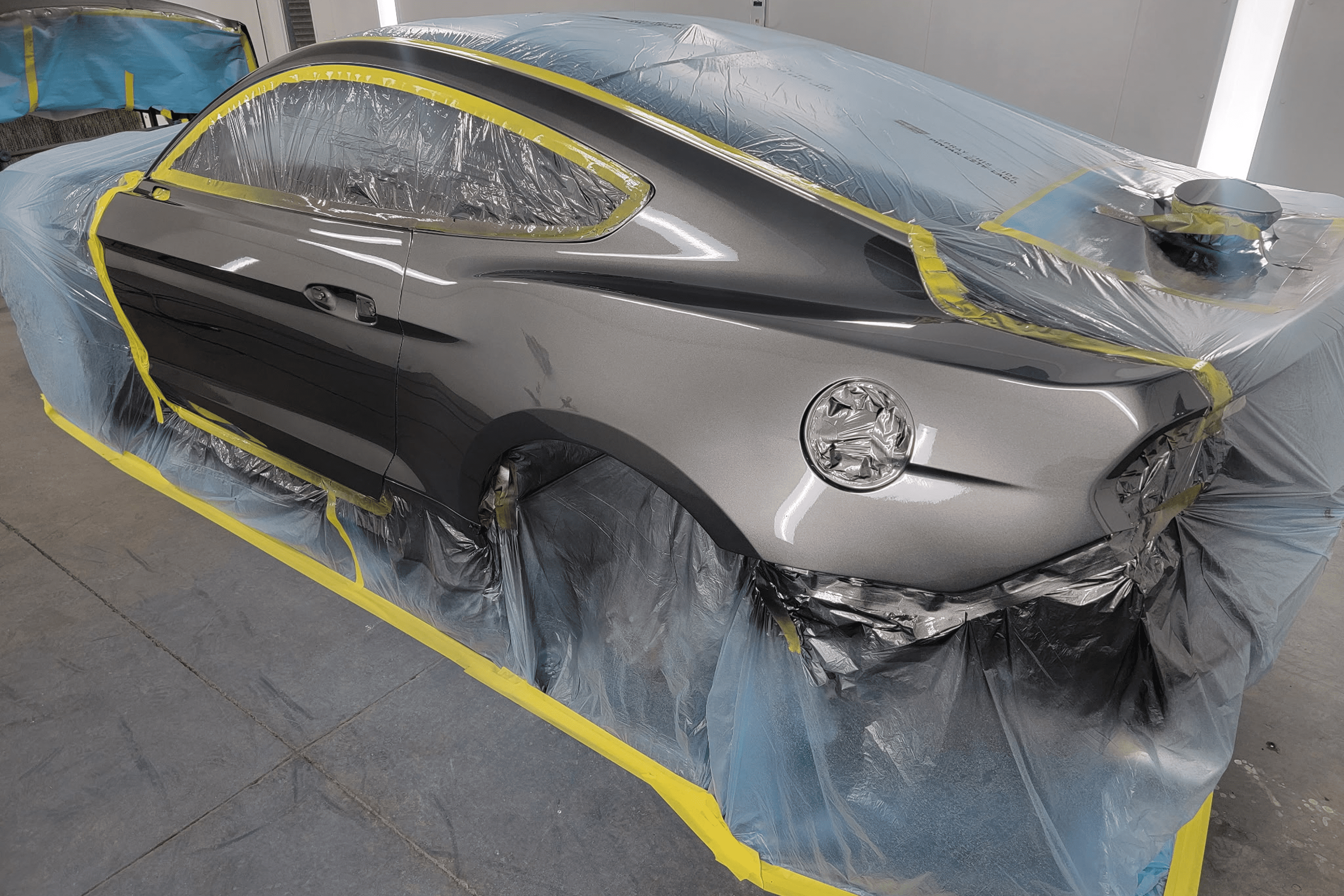 Car prepared for painting in workshop.